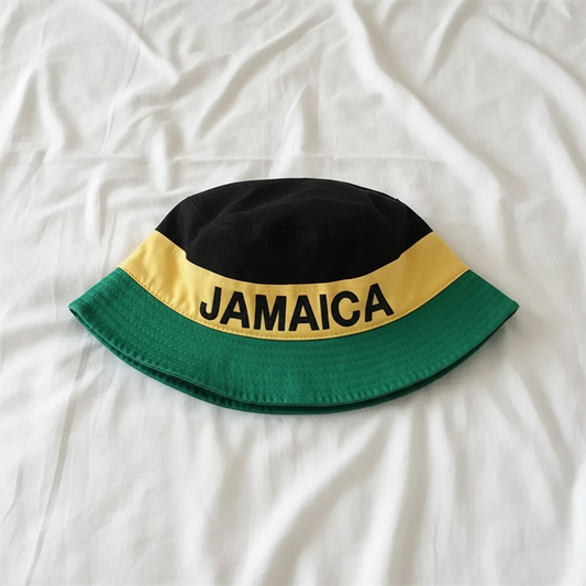 Jamaica Bucket Hat laid flat on a white bed sheet lifestyle photo